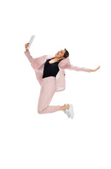 Flying. Happy young woman dancing in casual clothes or suit, remaking legendary moves and dances of celebrity from culture history. Isolated. Action, motion, fame concept. Creative occupation.