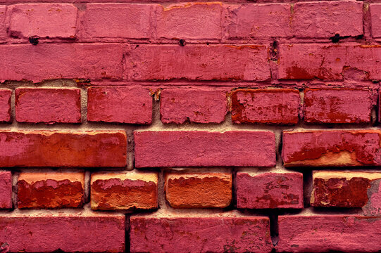 Macrofotography Of A Textural Old Brick Wall With Cracks And Scratches. Horizontal Wide Brick Background. Distressed Wall With Broken Brick Texture. Facade Of An Old House. Panoramic Building Backgrou