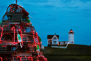 Holiday Nubble Lighthouse with Wooden Lobster Trap Tree in Foeground in Maine