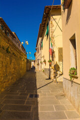 A quiet residential street in the historic medieval village of Batignano, Grosseto Province, Tuscany, Italy
