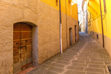 Fototapeta premium A quiet residential street in the historic medieval village of Batignano, Grosseto Province, Tuscany, Italy 