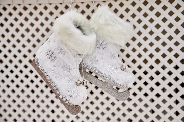 Christmas ice skates hang on the fireplace