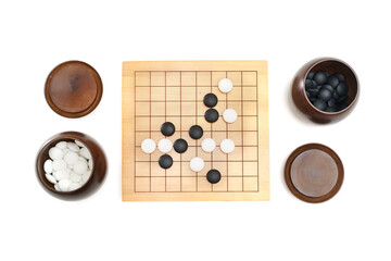 Go game stones in wooden bowls