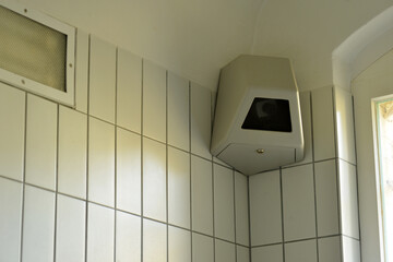 Fototapeta na wymiar Surveillance camera in a corner of a high secured jail cell