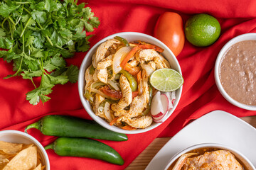 Chicken fajita burrito bowl with red and green pepper. Authentic Mexican food with spicy ingredients. 