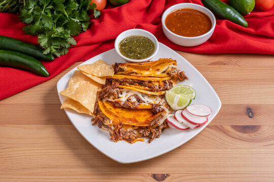 Birria tacos. Authentic Mexican street tacos made with steak, corn tortillas, and cheese. Fried birria barbacoa tacos. 