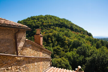 A view of the landscape over rooftops in the historic medieval village of Rocchette di Fazio near Semproniano in Grosseto Province, Tuscany, Italy

