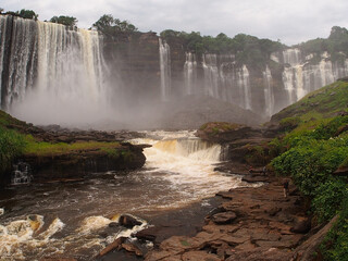 Calandula waterfall, river and green grass, jungle, water rushing, a big cascading waterfall, with green grass and jungle. in Angola