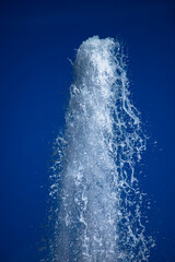 Water jet from a fountain in abstract design on blue sky background. Urban landscape.  Concept.