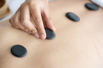 Fototapeta na wymiar Asian Woman Having a Hot Stone Massage Treatment