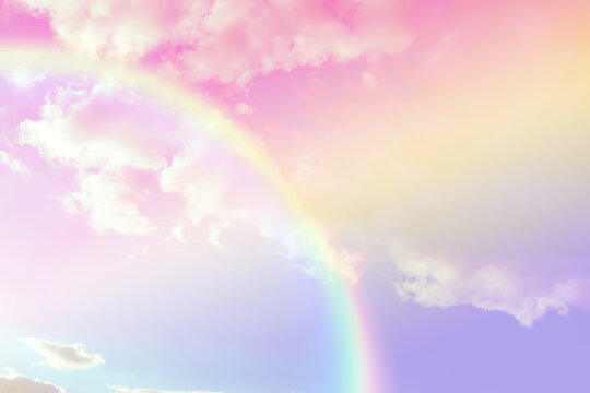 Amazing sky with rainbow and fluffy clouds, toned in unicorn colors