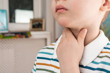 sore throat in a child. the child has a sore throat. signs of a cold in children