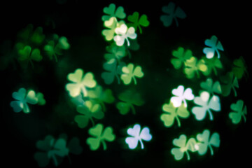 background texture with glowing blurred green clover leaves