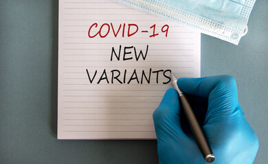 Covid-19 new variants symbol. Hand in blue glove with pen, white card. Concept words 'Covid-19 new...