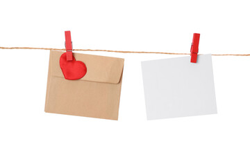 Blank card and envelope hanging on twine against white background. Valentine's Day celebration