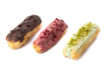 chocolate, berry and pistachio eclairs isolated on white background. Food concept. Top view