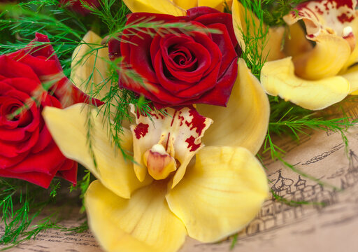 Bouquet of red roses and yellow orchids