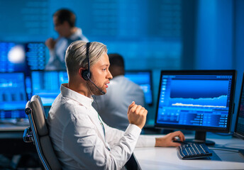 Team of brokers is working in office using workstation and analysis technology. Workplace of...