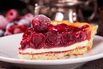 Cheesecake with cherry. Piece of cake on white plate