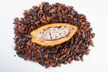 Cocoa fruit cut with raw cocoa beans on a white background