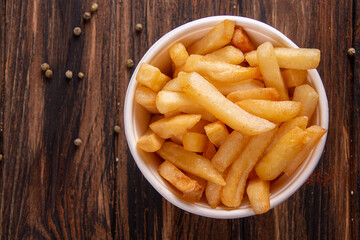 French fries chips potato on wooden background. top view