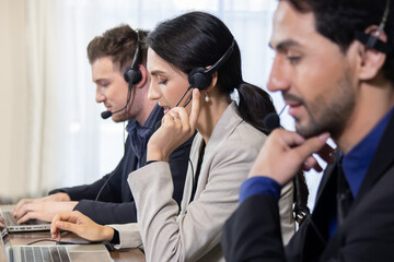Side View of Telemarketing Colleagues with Headset Talking with Their Clients