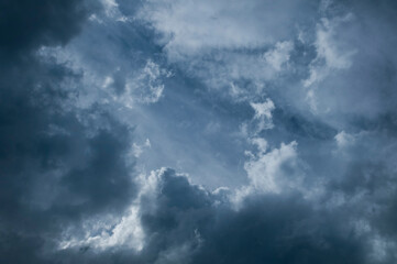 Naklejka na ściany i meble Dramatic dark blue sky with heavy clouds background