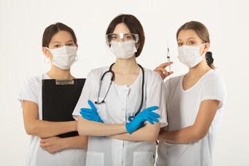 three young women in medical clothes on a white background