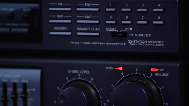 The man turns on the stereo mode on the retro radio.