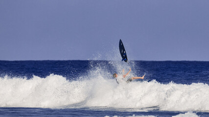 surfing board in the air After a surfer falls into the water. Water sport activity, surfboard in the air