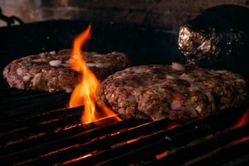 steel grilled meat burger with wood flame fries in metallic foil herbs oregano cordoba argentina