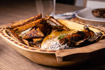 steel grilled meat burger with wood flame fries in metallic foil herbs oregano onions cordoba argentina