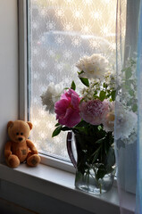 summer bright bouquet with peony and Jasmine flowers on window of country house