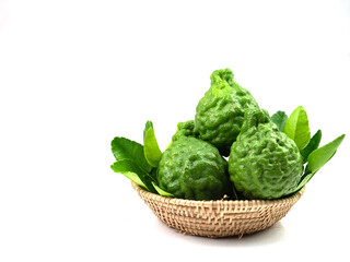 Bergamot and leaves in a basket, isolated on a white background