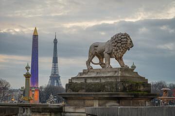 Paris,France - 12 30 2020: View of the Luxor Obelisk, the lion sculpture and the Eiffel tower from...