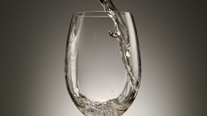 Pouring white wine into wine glass