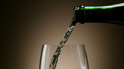 Pouring white wine into wine glass