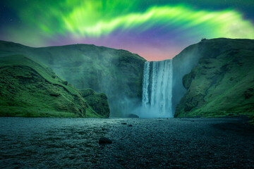 Fototapeta na wymiar Green aurora light behind famous Skogafoss waterfall on Skoga river. Iceland, Europe. Courtesy of NASA. Photo collage