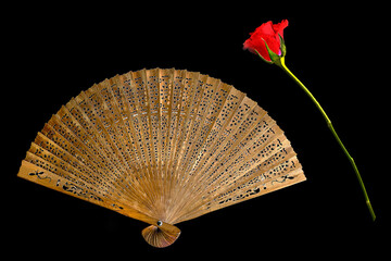 Old wooden shed fan with a red rose