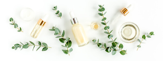 Eucalyptus essential oil, eucalyptus leaves on white background. Natural, Organic cosmetics products. Medicinal plant. Natural Serums. Flat lay, top view.