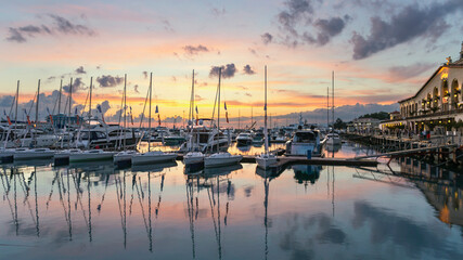 small sailboats in the harbor of the Sochi seaport against the background of the sea station