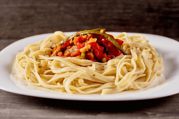 spaghetti with fried eggplant and tomatoes and sweet and sour sauce
