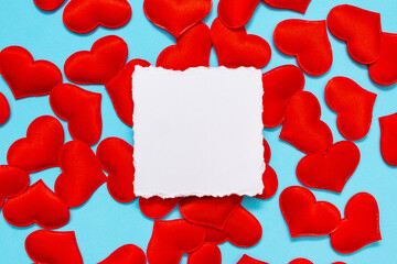 Creative layout of red hearts on a blue background. Minimal valentine's day greeting card with copy space. Border arrangement background.