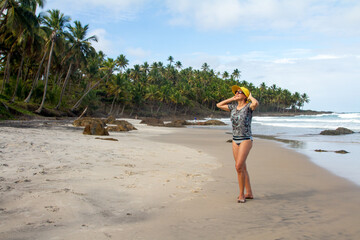 Fototapeta na wymiar Woman enjoying herself at one of the many nearly deserted beaches in the Northeast of Brazil