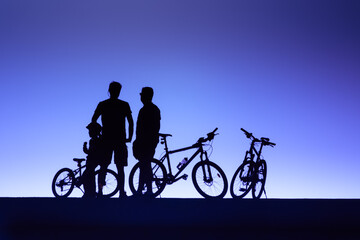 Obraz premium sport background with silhoettes of biker and mountain bikes