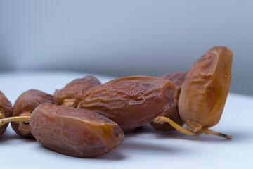 dried dates in branch on white background