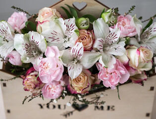 Flower arrangement of delicate roses in a wooden box. Mother Day, Valentine, love concept