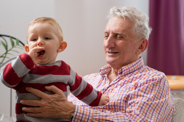 Grandfather with their little grandchild resting at home