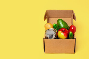 Contactless set of finished product kit. Front view with grocery box on yellow background.