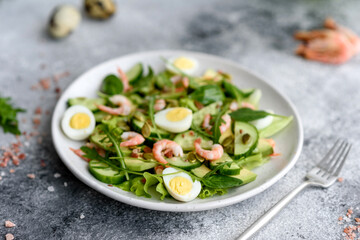 Salad with shrimp, avocado, cucumber, pumpkin seeds and flax seeds with olive oil